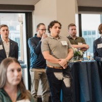 Group of GVSU Alumni listening to speaker